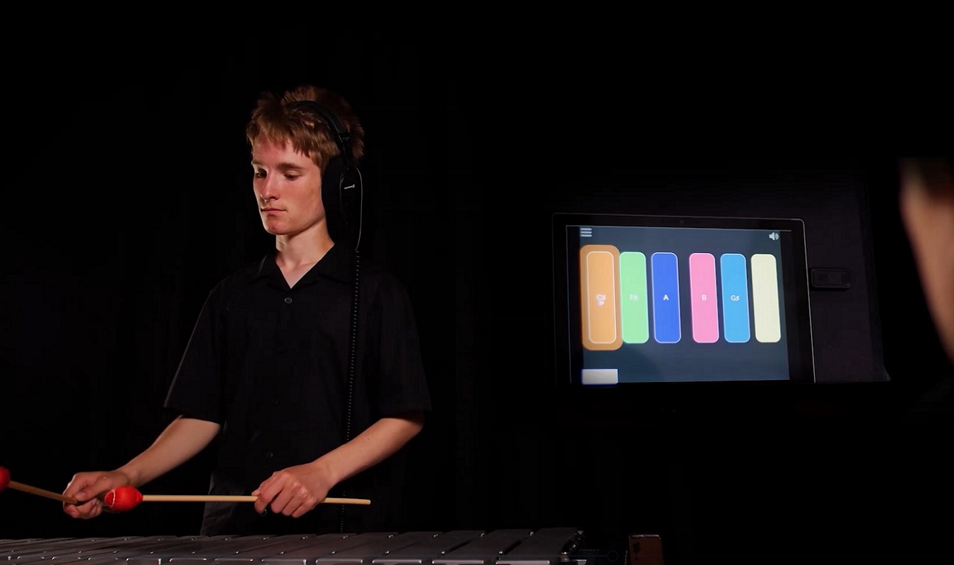 Two NOYO musicians are playing - one on percussion, the other on Clarion, an accessible electronic instrument