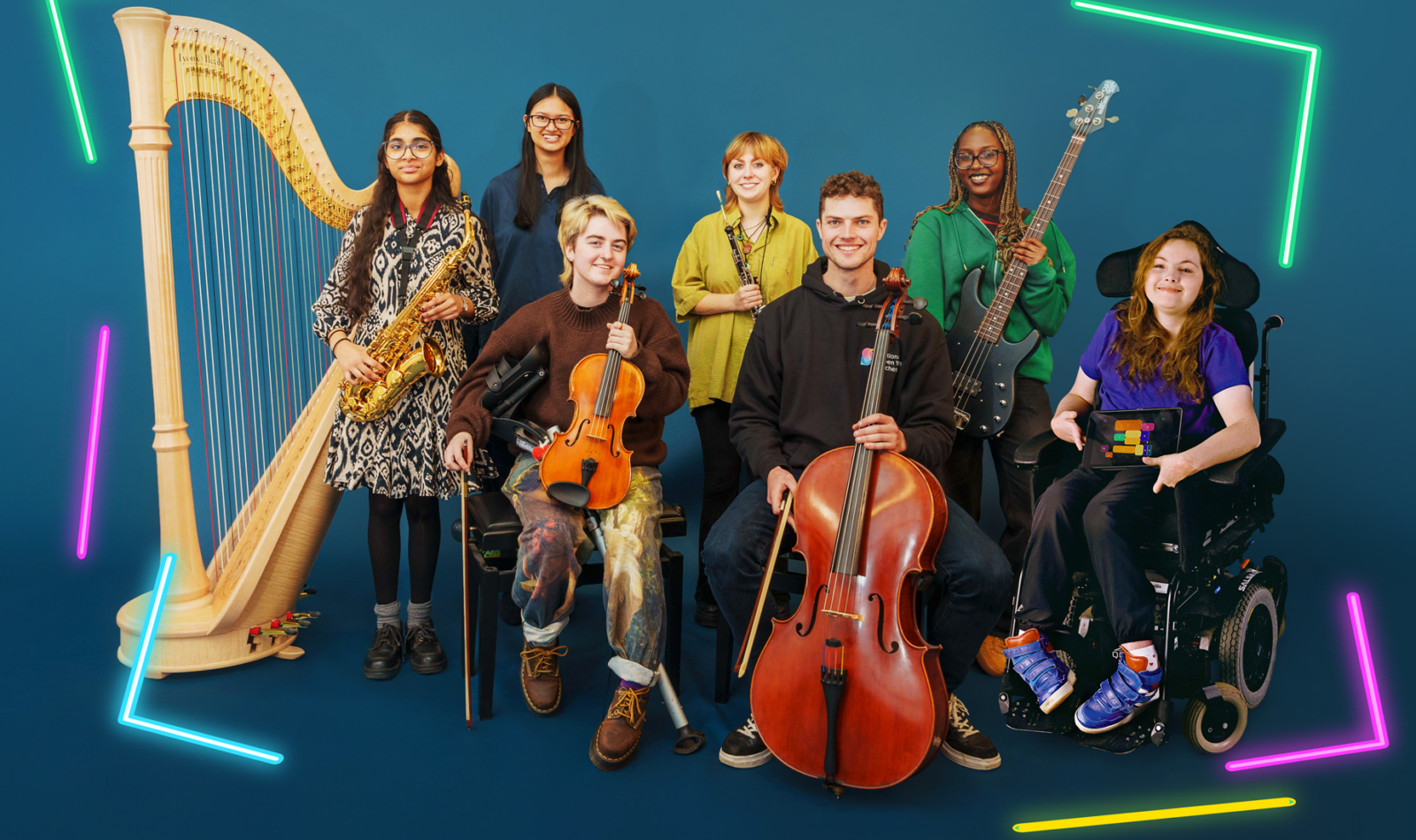 A group of seven disabled an non-disabled musicians pose with a mix of acoustic, electornic and accesible instruments.