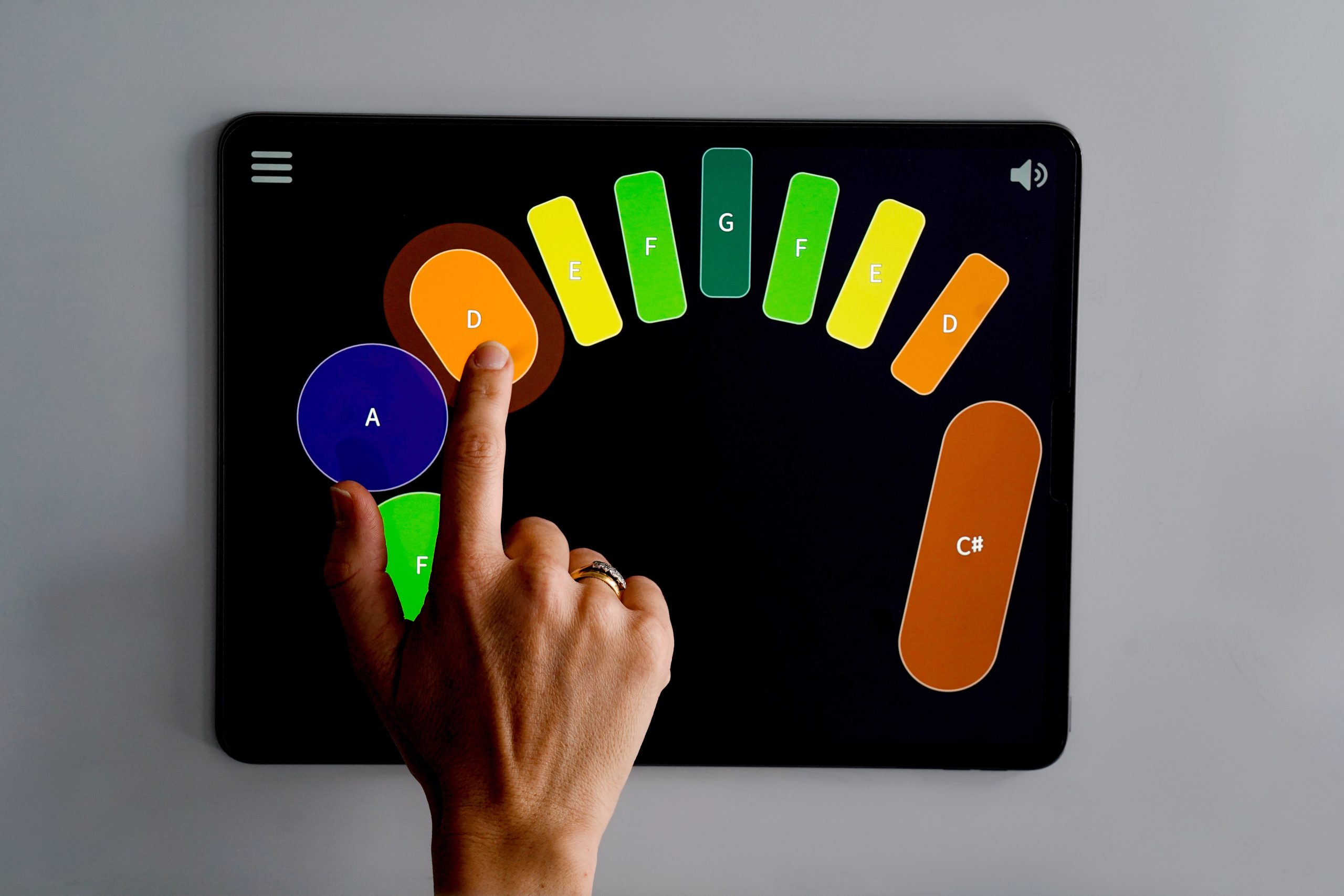 A hand plays one of the patterns included in The Orchestra: A Young Person's Guide collaboration.